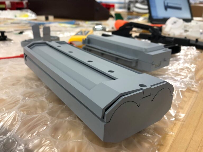 Early grey molded plastic prototype of toy disc blaster