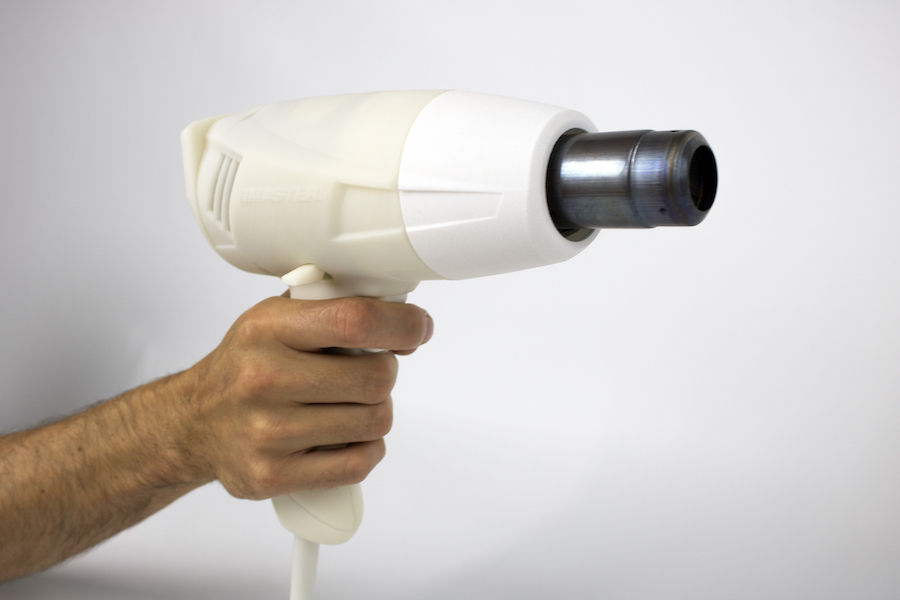 Hand holding unpainted prototype of pro heat gun tool