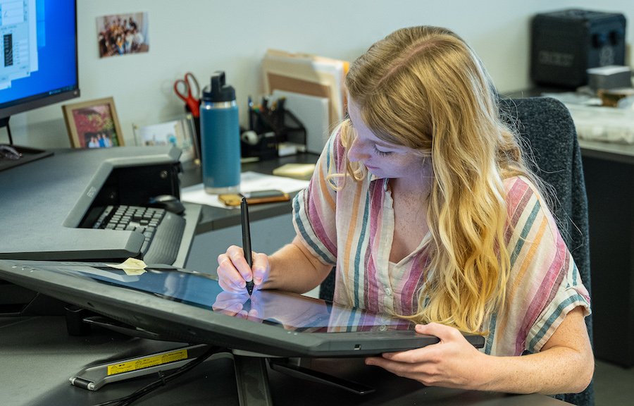 Female industrial designer drawing on a tablet