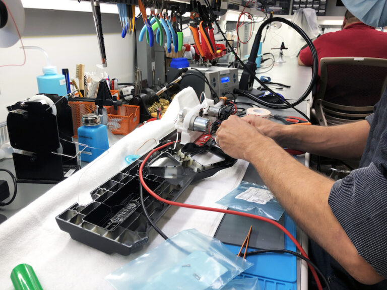 Hands assembling components in the Technology Lab