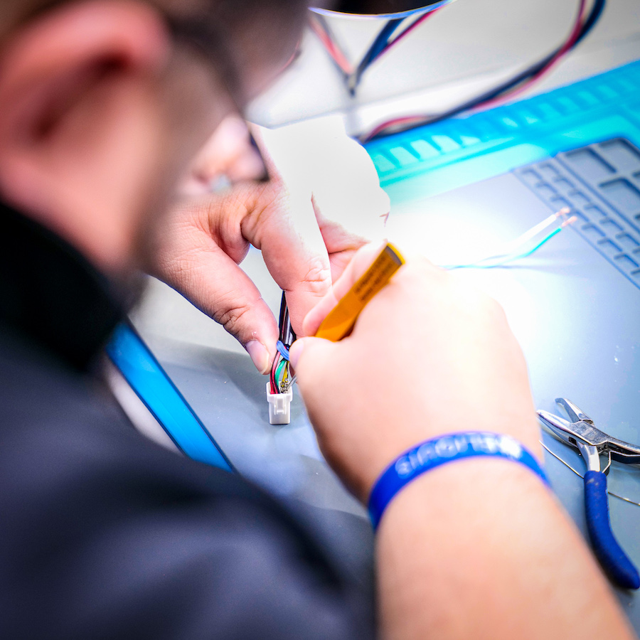 Shot over the shoulder of electrical engineer assembling circuits