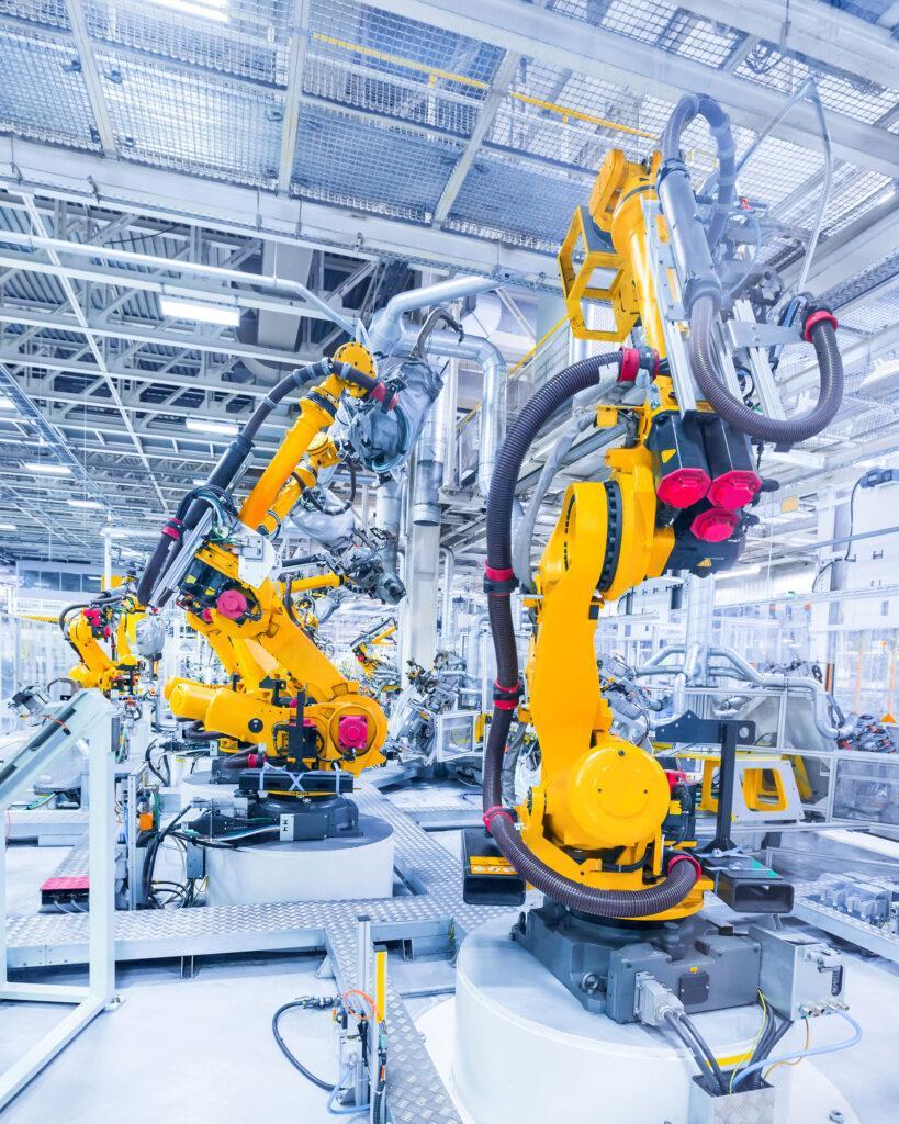 Robotic arms working on an industrial assembly line